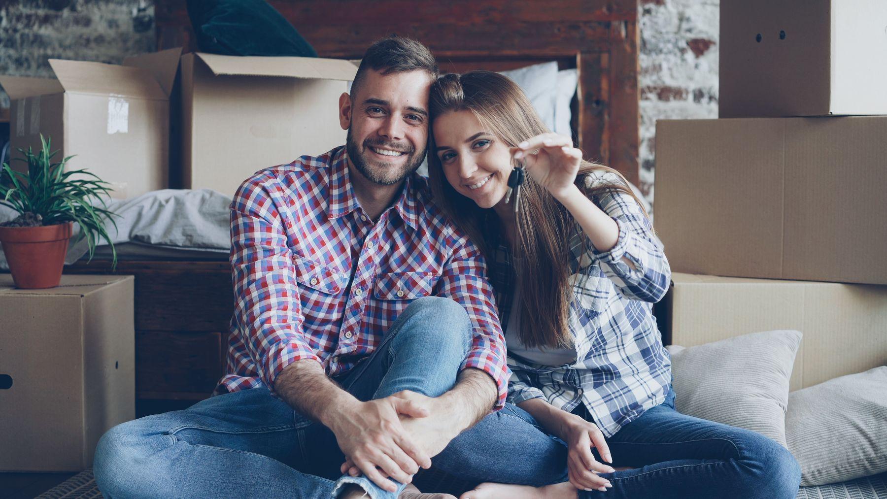 A couple celebrating their new home with the keys
